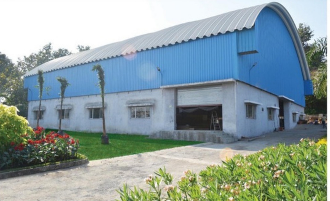 The Kshitij Interiors manufacturing facility at Wada, Maharashtra, seen from the approach road.