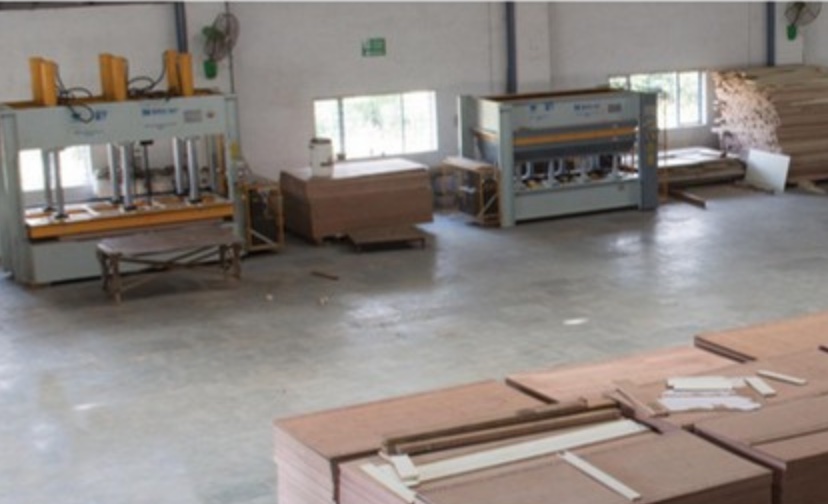 Cold and hot presses on the Wada factory floor, used for lamination and veneer bonding.